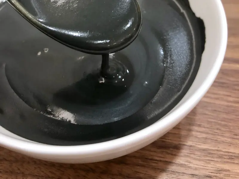 Glossy black sesame soup in a bowl