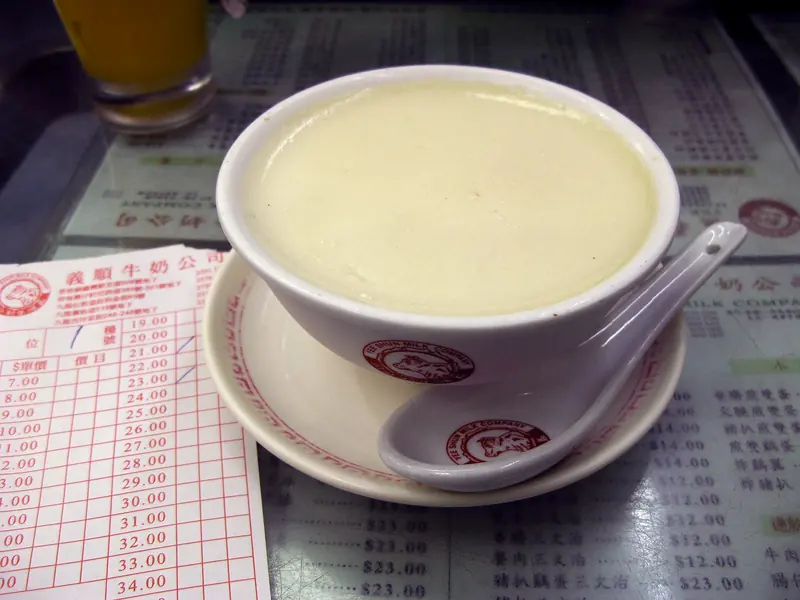 Ginger milk curd in a cafe bowl with a spoon