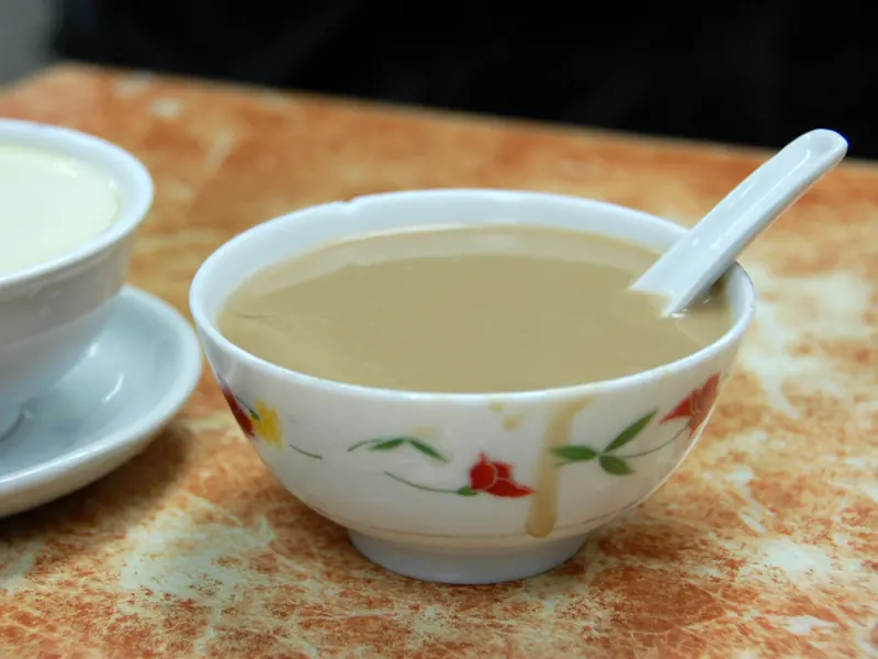 Walnut sweet soup with a porcelain spoon